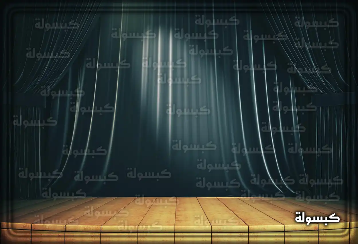 رجل يقف على خشبة مسرح مضاءة